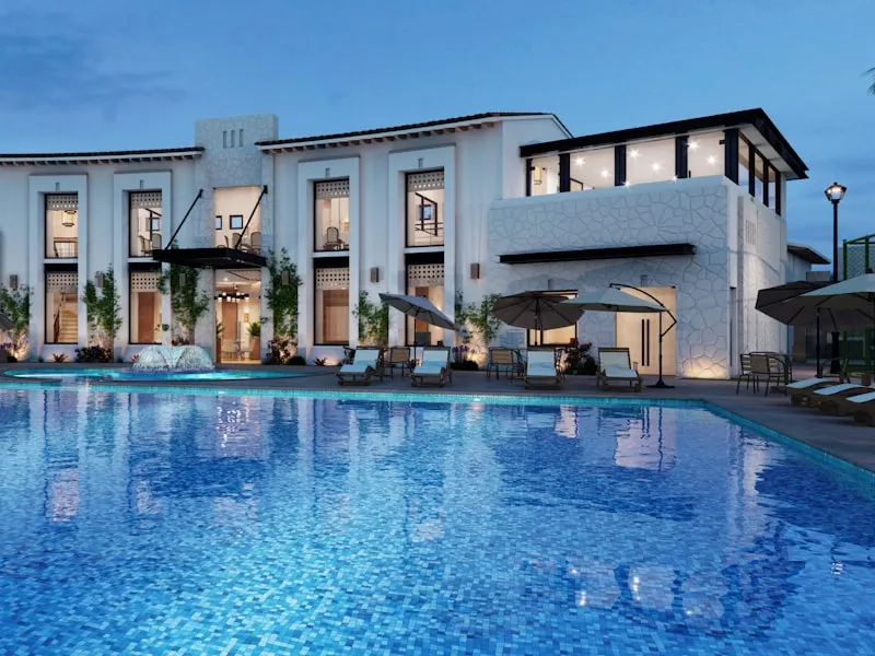 Whitewashed Moorish resort with a lantern-lit courtyard pool at dusk in Marrakech